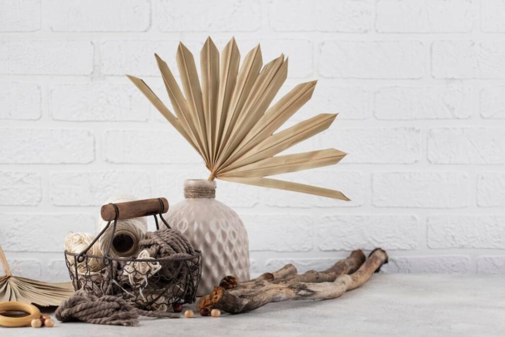 A decorative arrangement featuring a beige vase with a fan-shaped plant.
