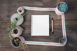 A blank notebook sits on a wooden surface.