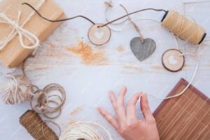 A hand reaches for crafting supplies.