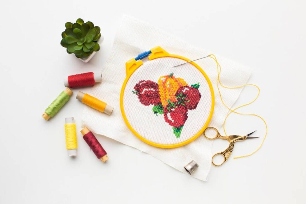A colorful cross-stitch pattern featuring red and yellow peppers.