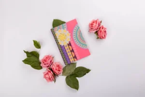 A colorful diary surrounded by pink roses and green leaves.